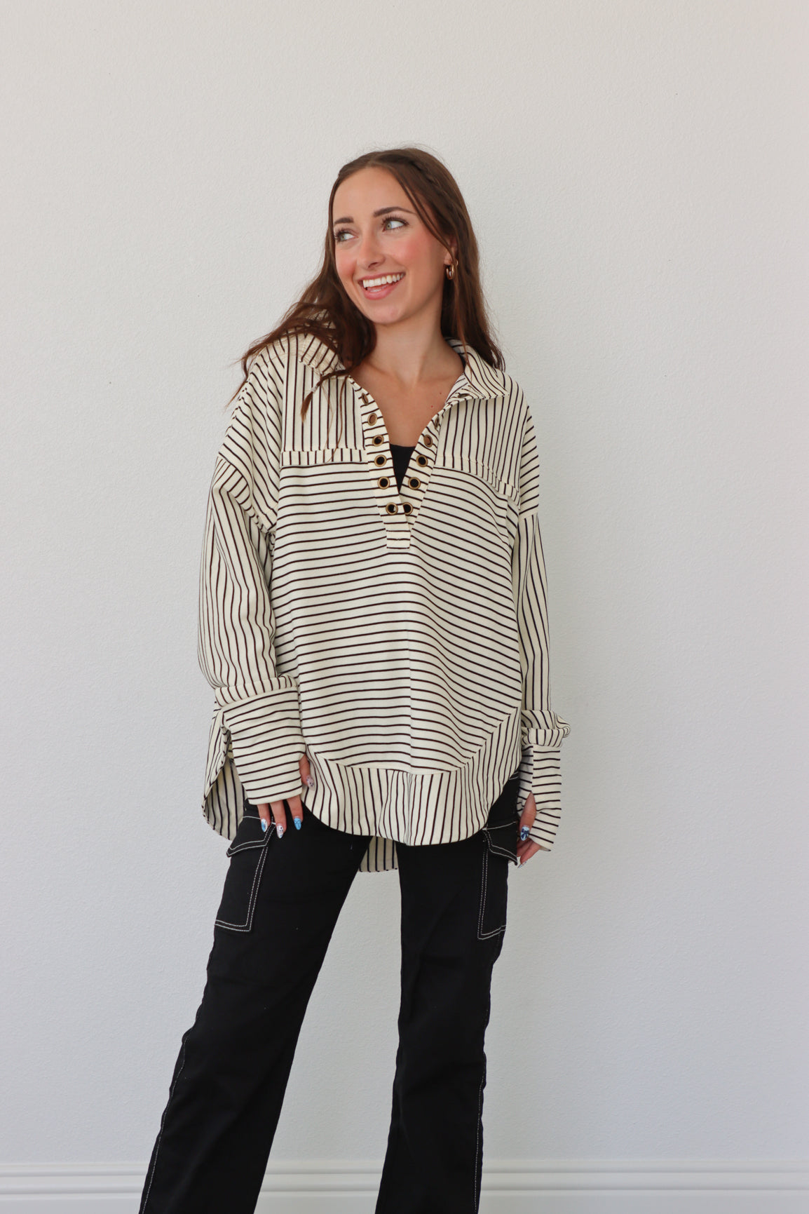 girl wearing cream pullover with black stripes