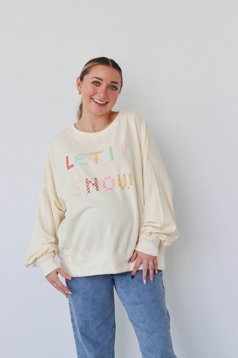 girl wearing cream "let it snow" top