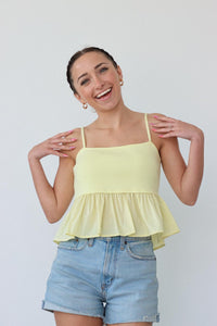 girl wearing yellow tank top