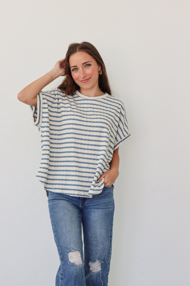 girl wearing white tee with blue stripes