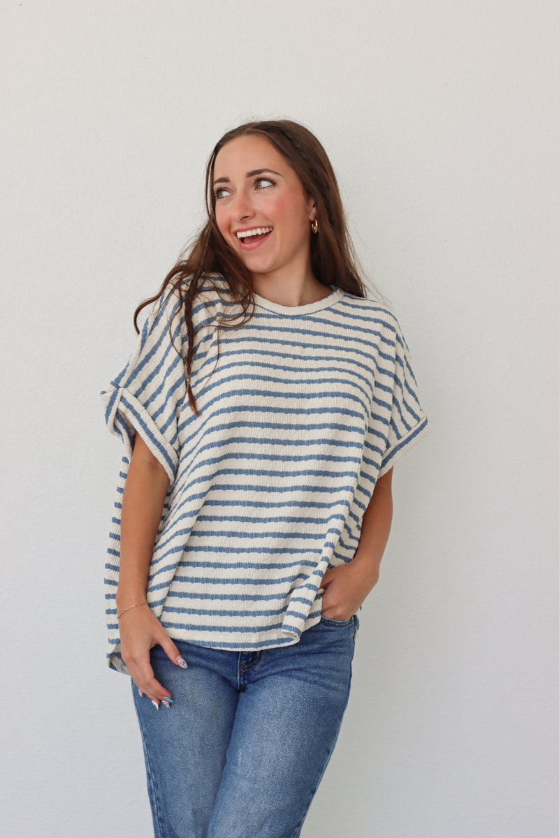 girl wearing white tee with blue stripes