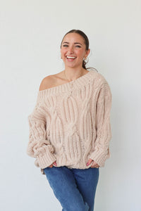 girl wearing cream cable knit loose oversized sweater