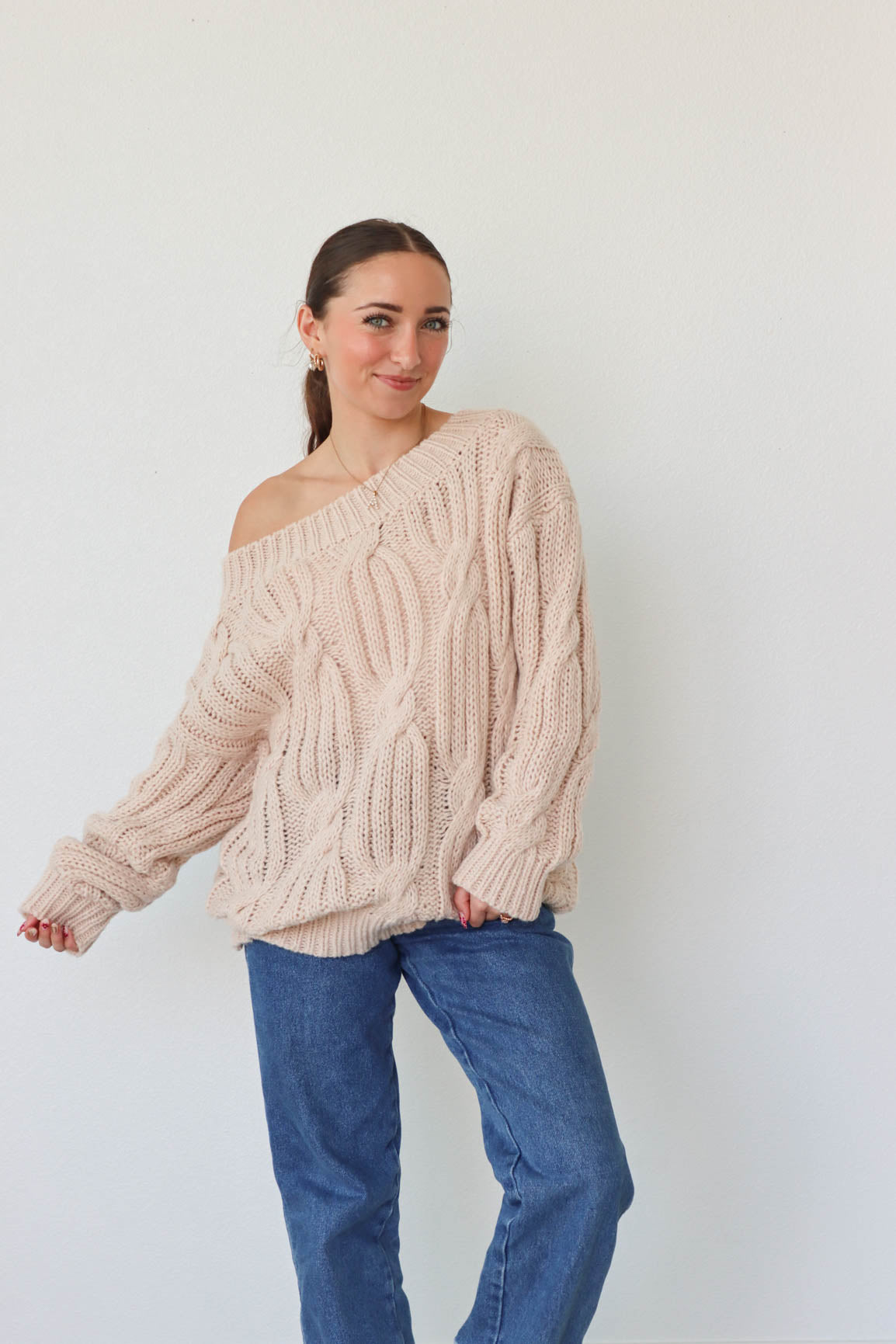 girl wearing cream cable knit loose oversized sweater