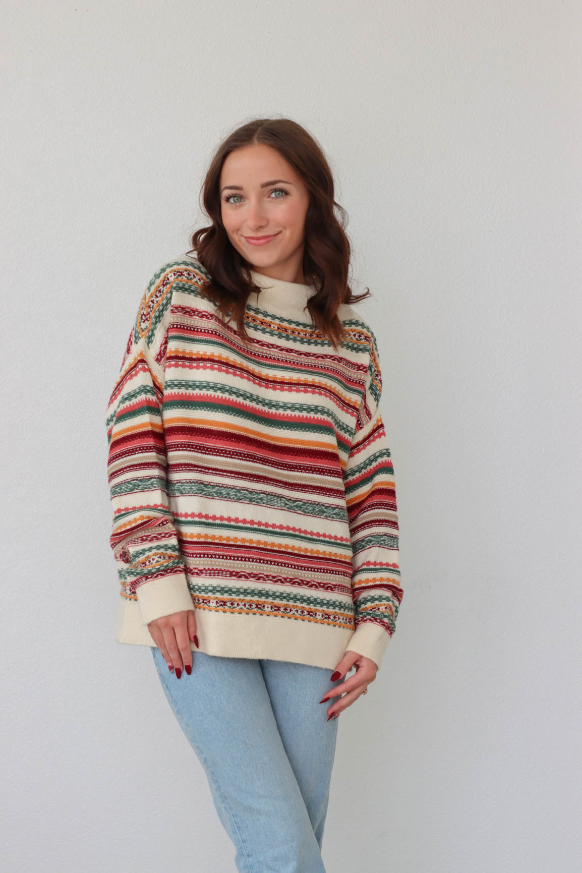 girl wearing multicolored knit long sleeved sweater