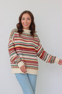 girl wearing multicolored knit long sleeved sweater