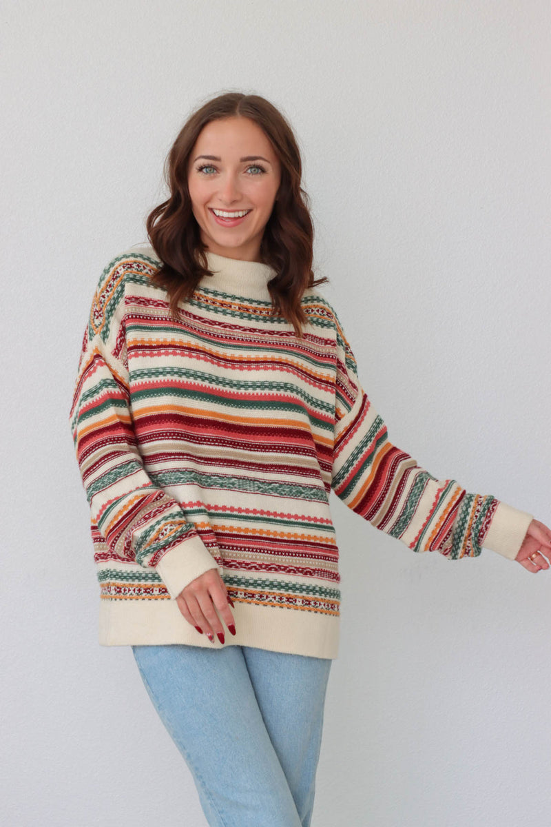 girl wearing multicolored knit long sleeved sweater