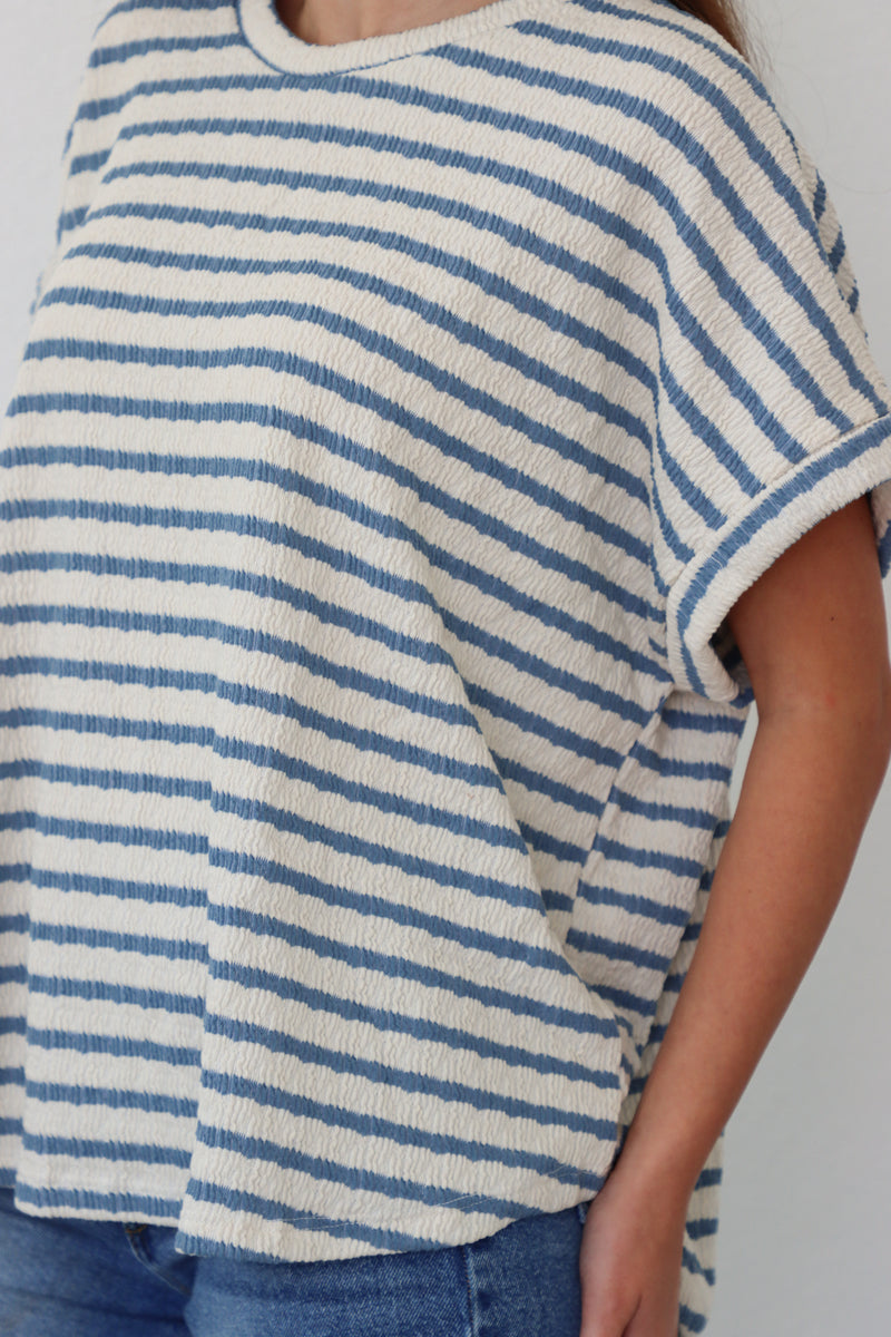 girl wearing white tee with blue stripes