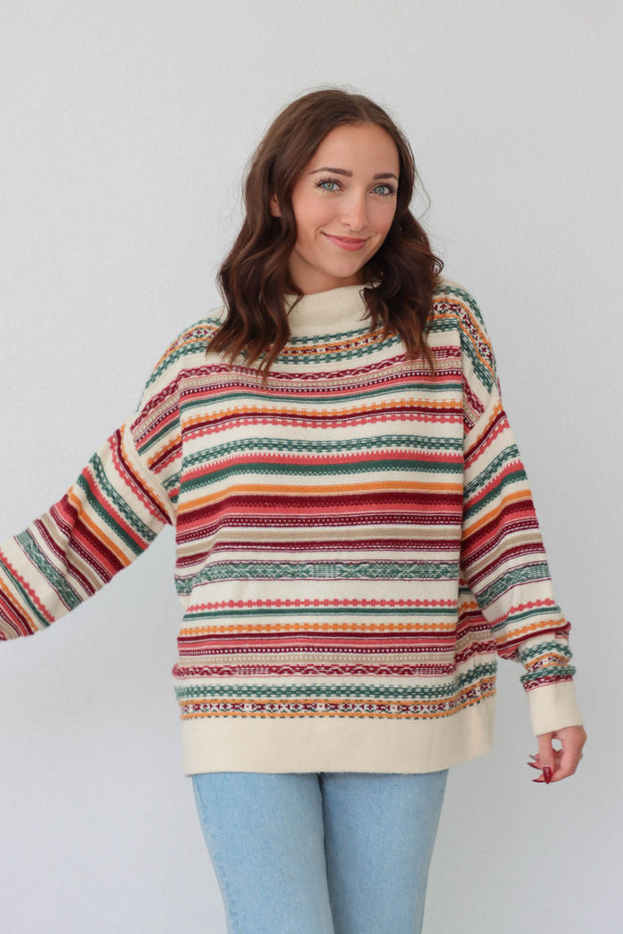 girl wearing multicolored knit long sleeved sweater