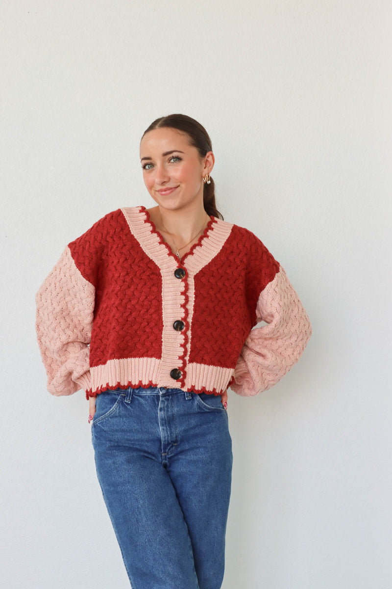 girl wearing red and pink cardigan