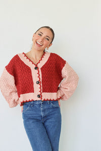 girl wearing red and pink cardigan