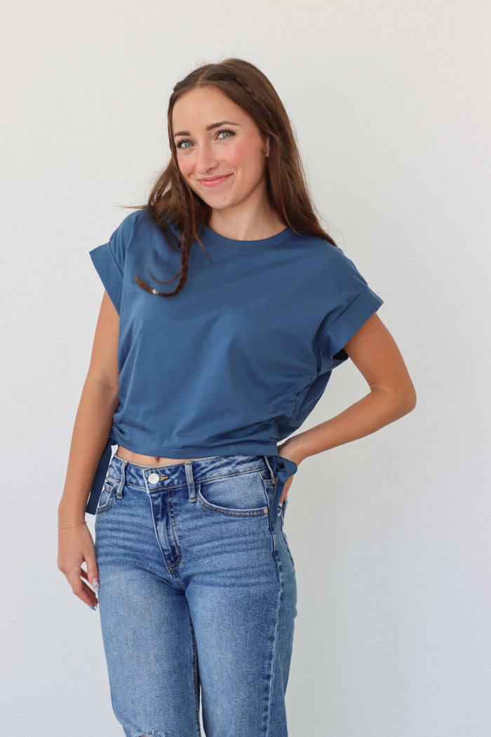 girl wearing dark blue cropped tee