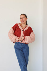 girl wearing red and pink cardigan