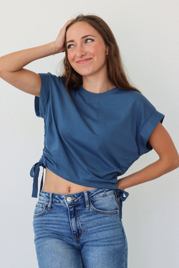 girl wearing dark blue cropped tee