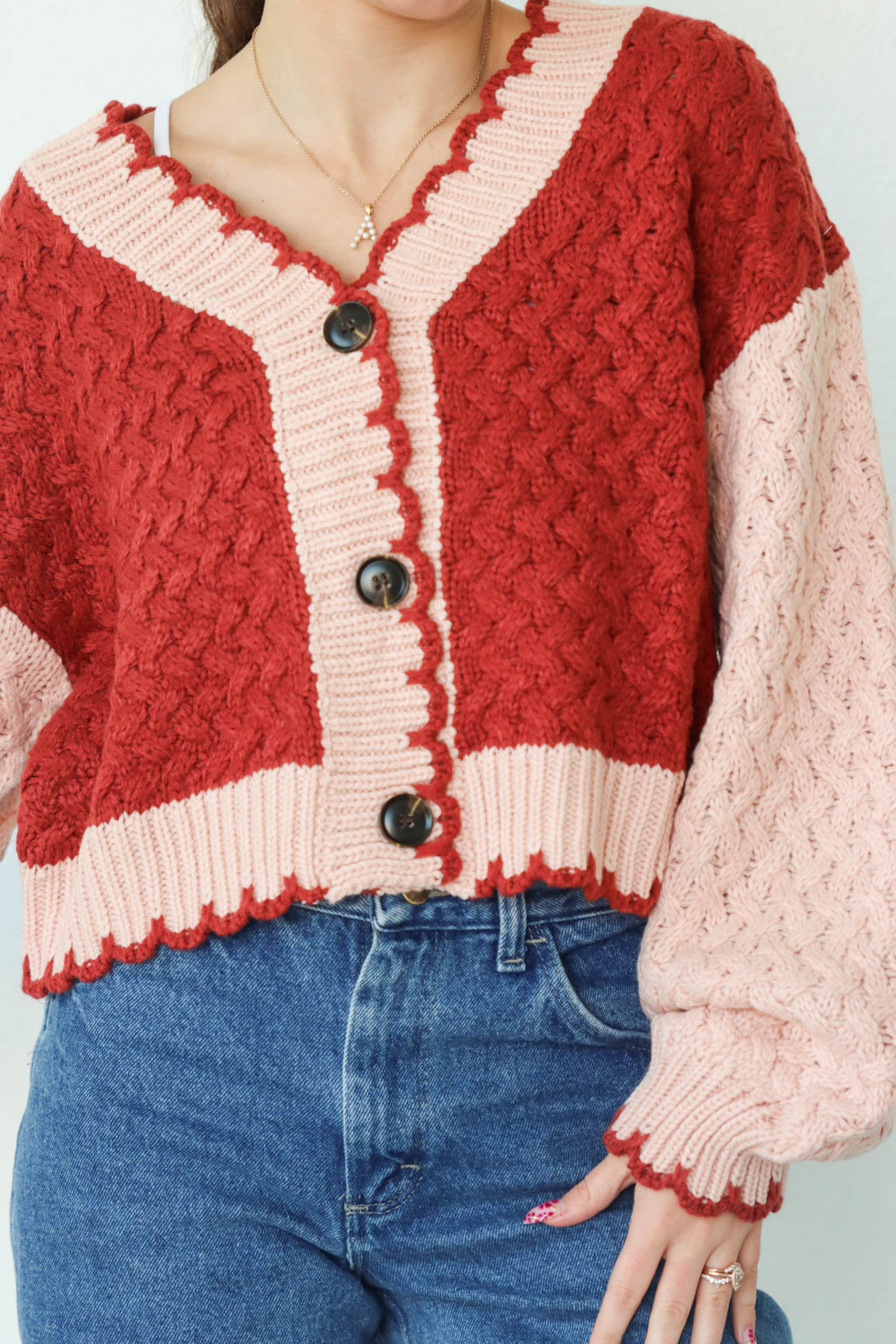 girl wearing red and pink cardigan