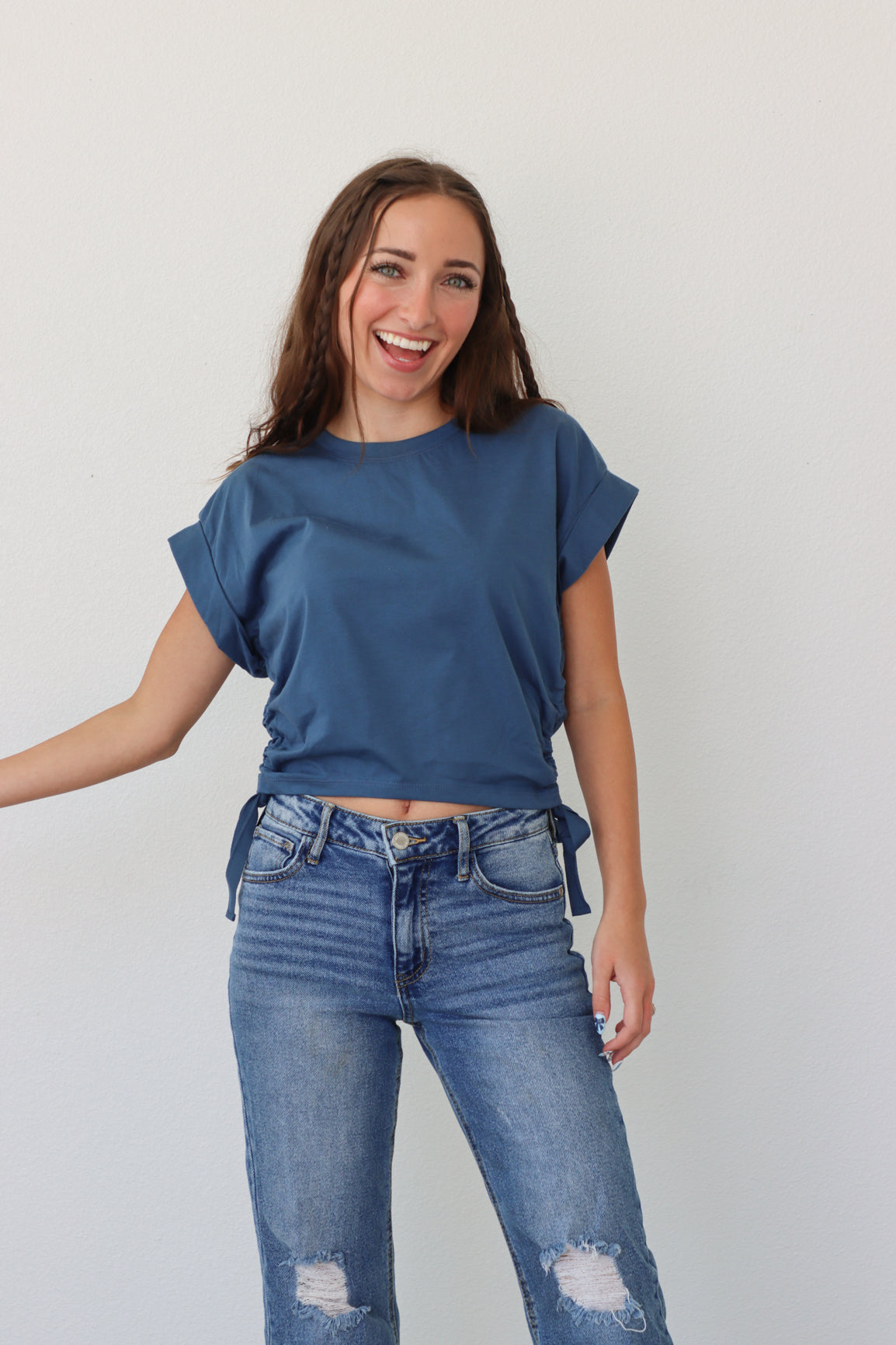 girl wearing dark blue cropped tee