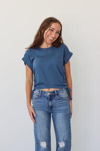 girl wearing dark blue cropped tee