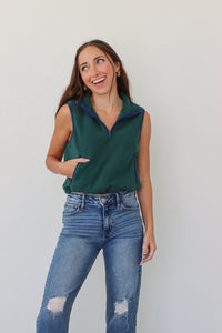 girl wearing dark green cropped, fleece vest