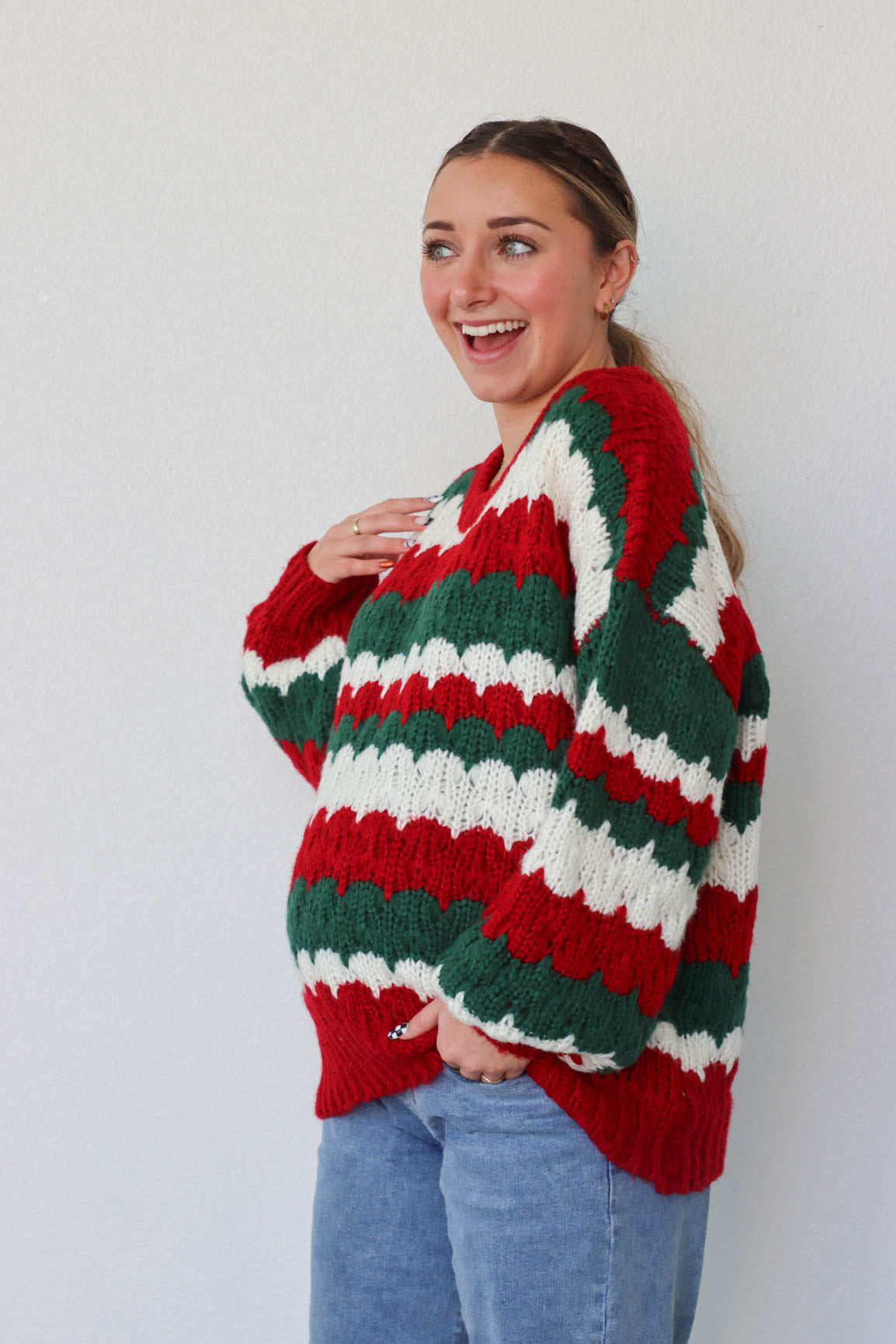 girl wearing red, green, and white knit sweater