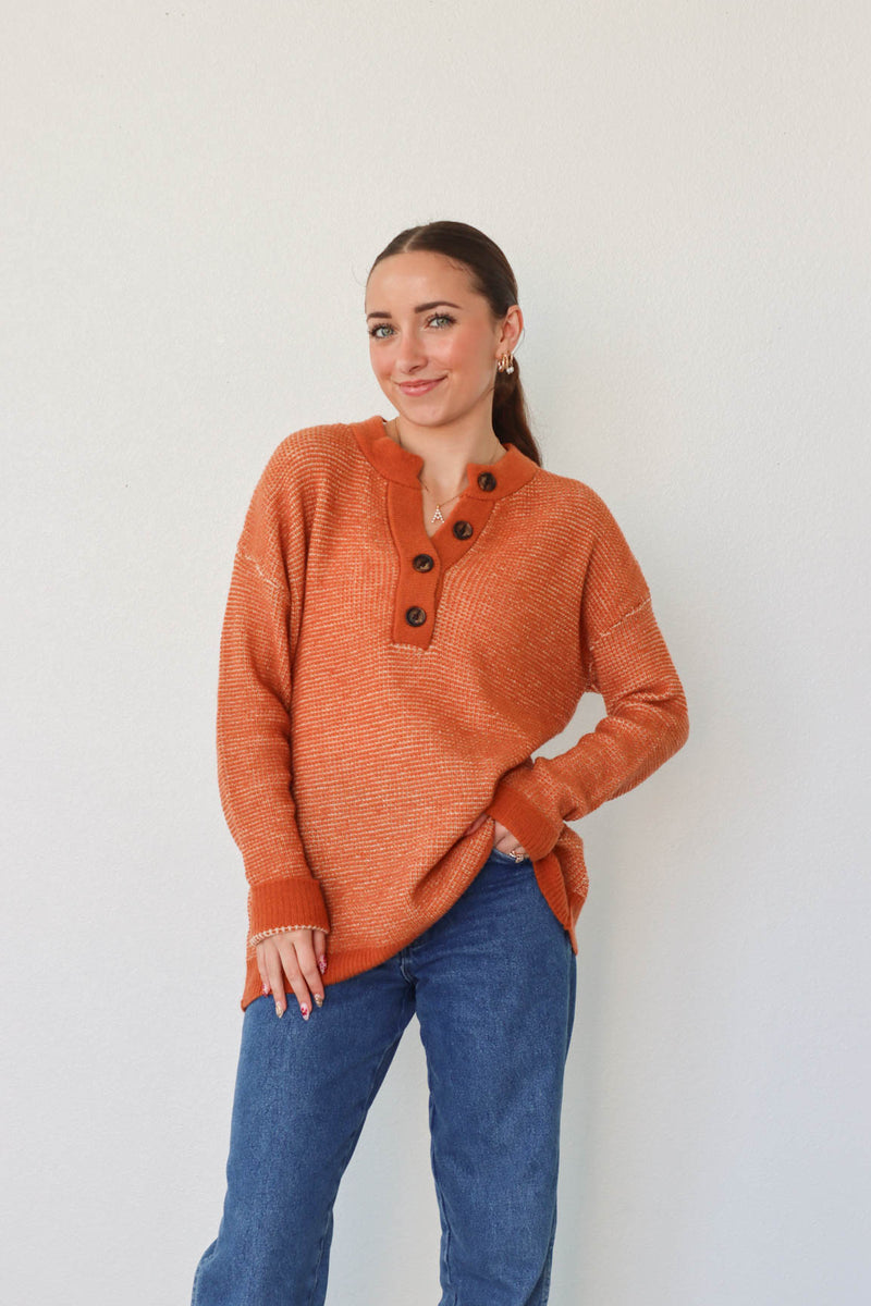 girl wearing orange long sleeved sweater