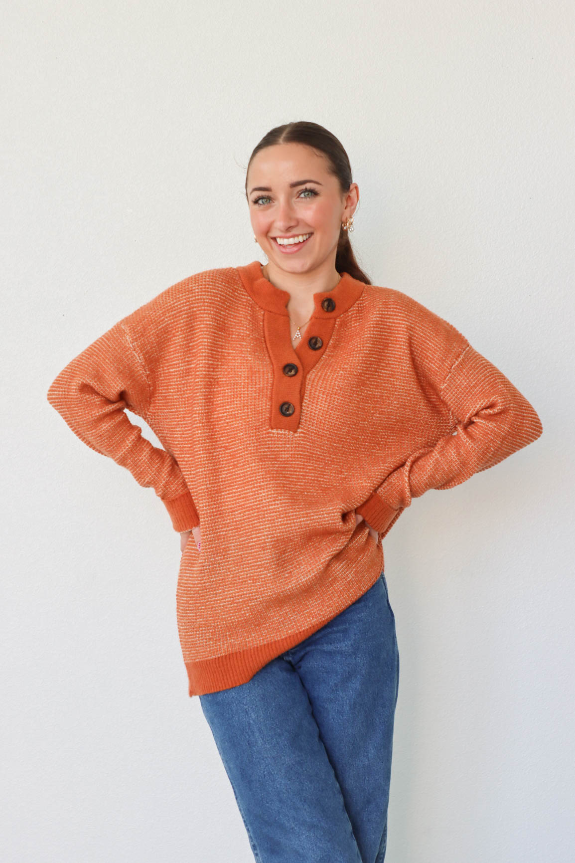 girl wearing orange long sleeved sweater