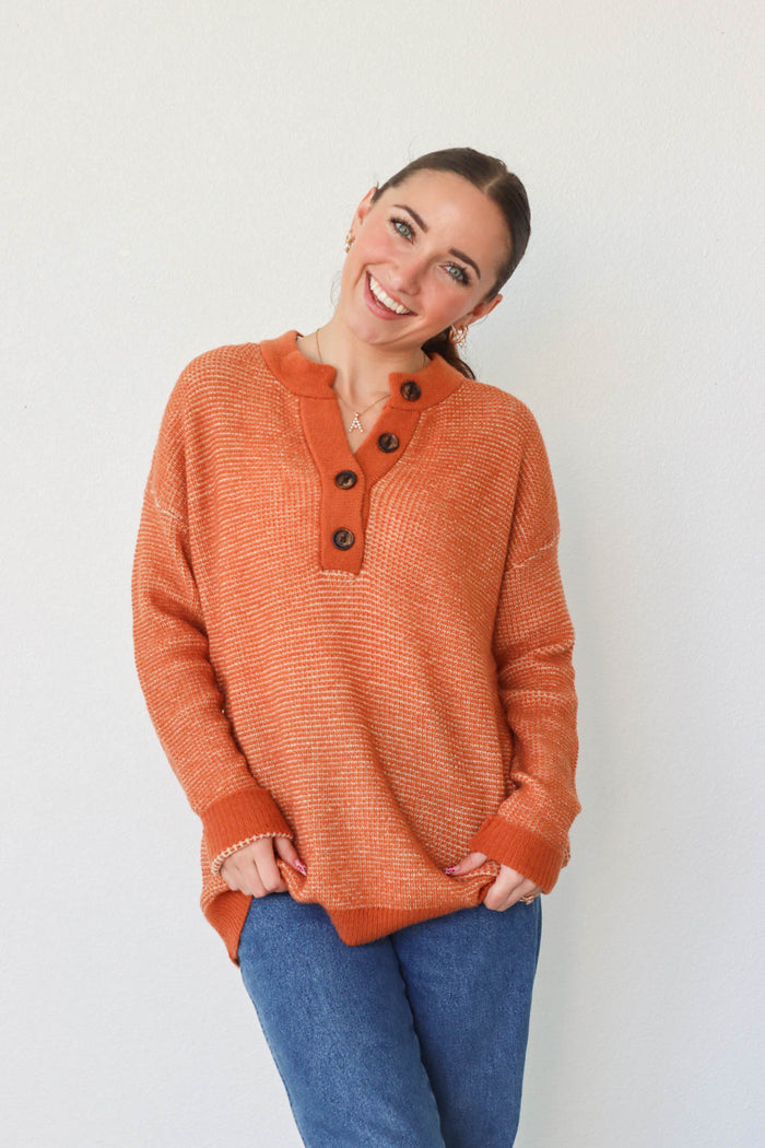 girl wearing orange long sleeved sweater