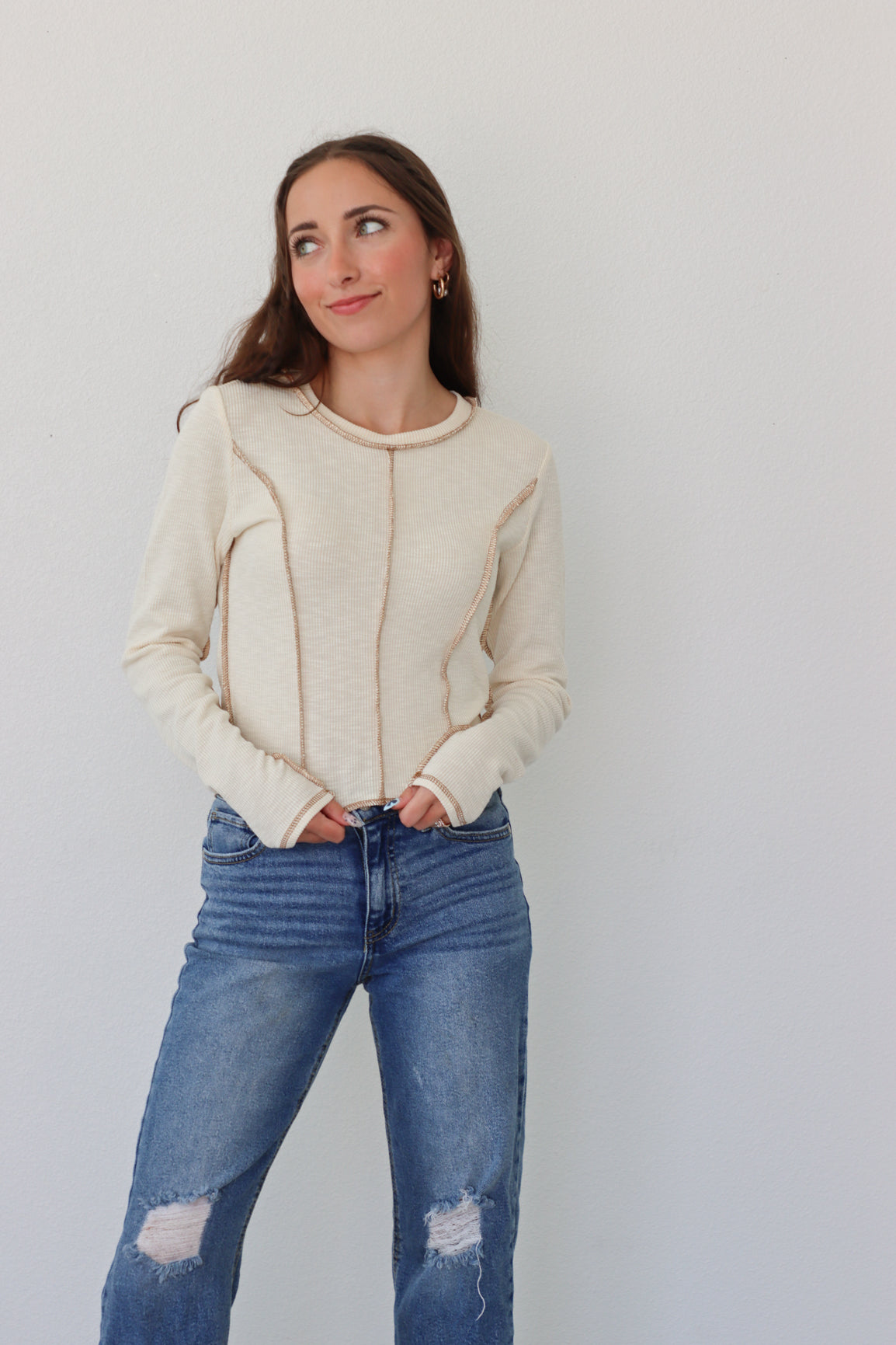 girl wearing cream long sleeve top