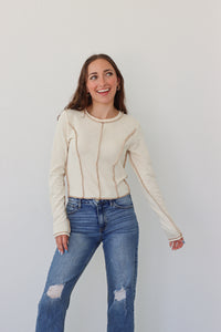 girl wearing cream long sleeve top