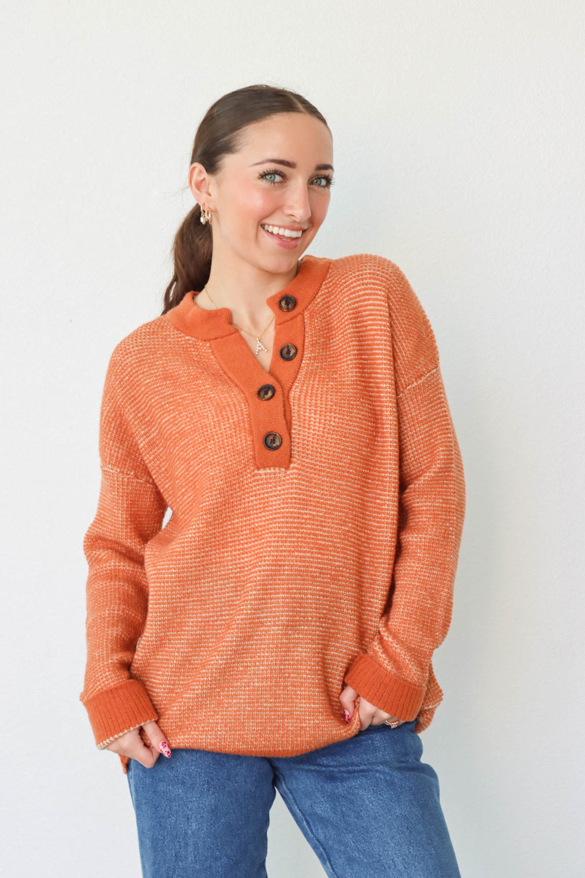 girl wearing orange long sleeved sweater