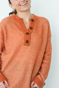 girl wearing orange long sleeved sweater