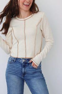 girl wearing cream long sleeve top