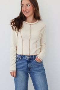 girl wearing cream long sleeve top