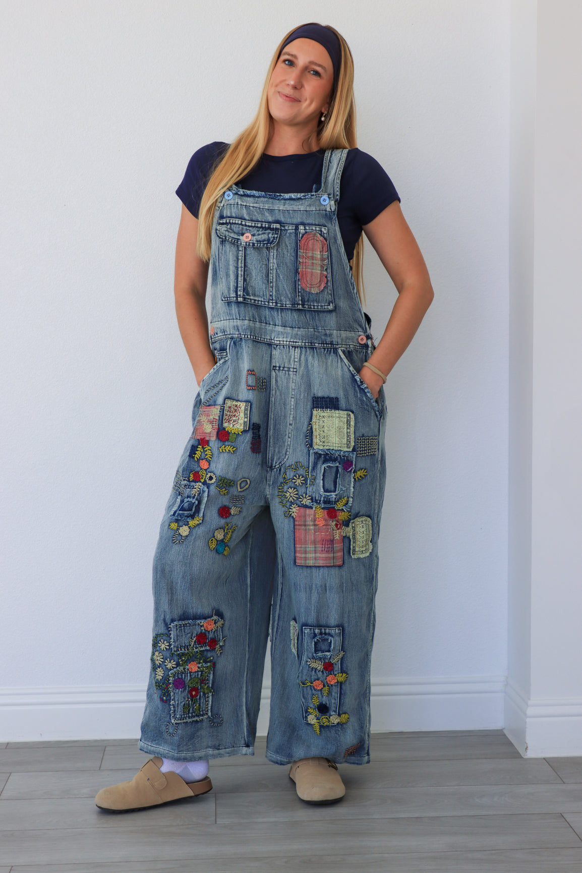 woman wearing patchwork blue overalls