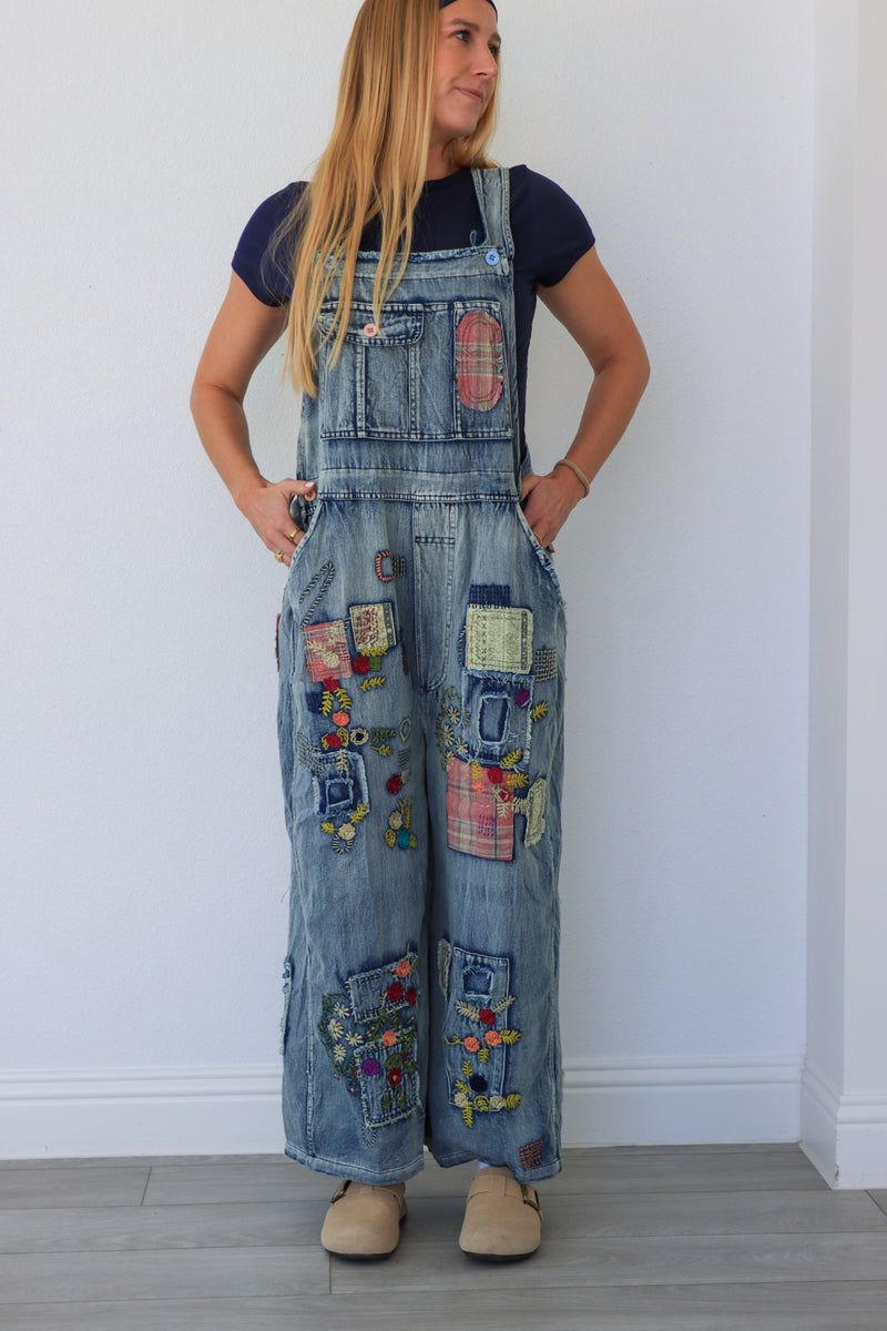 woman wearing patchwork blue overalls