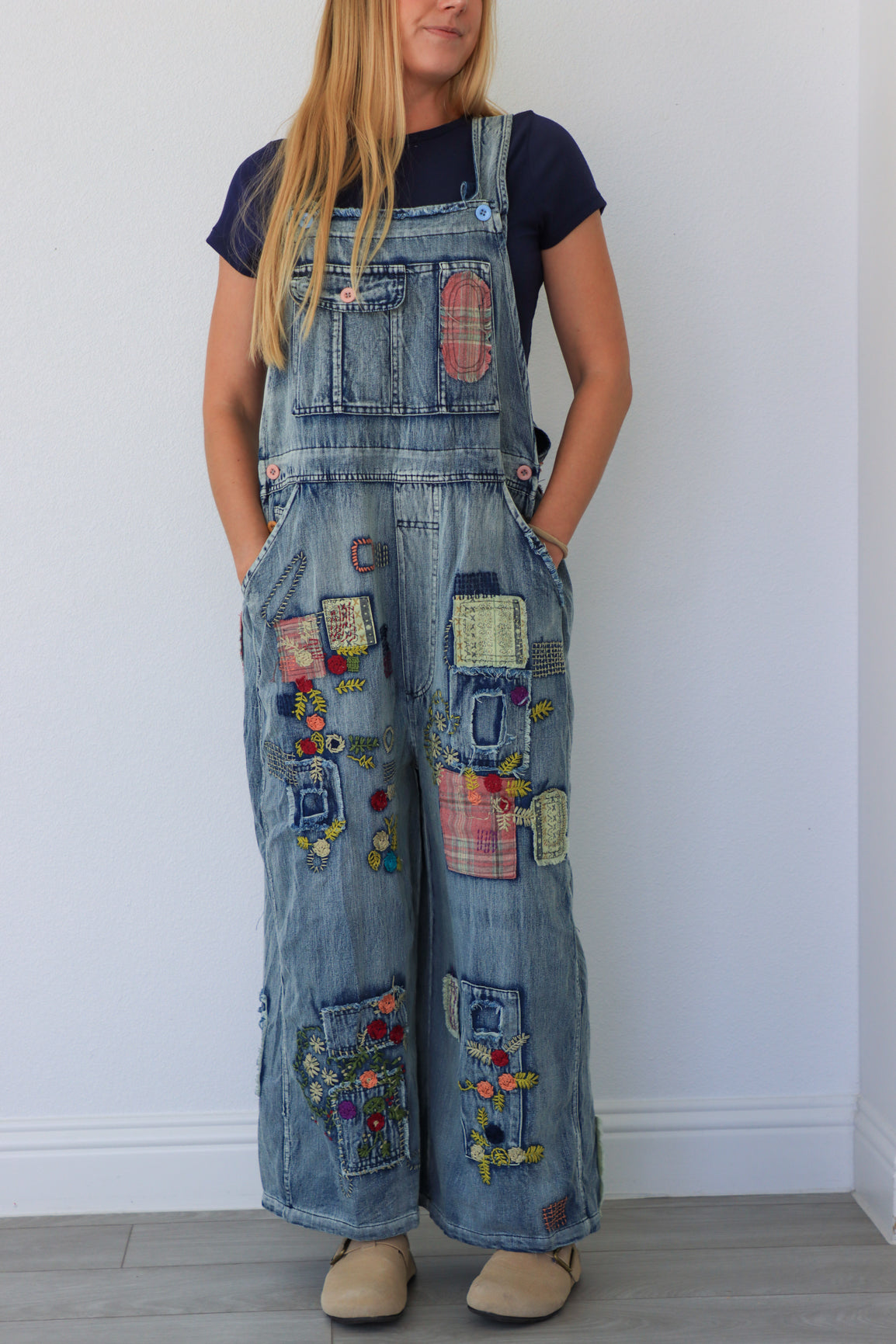 woman wearing patchwork blue overalls