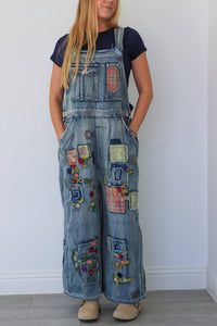 woman wearing patchwork blue overalls