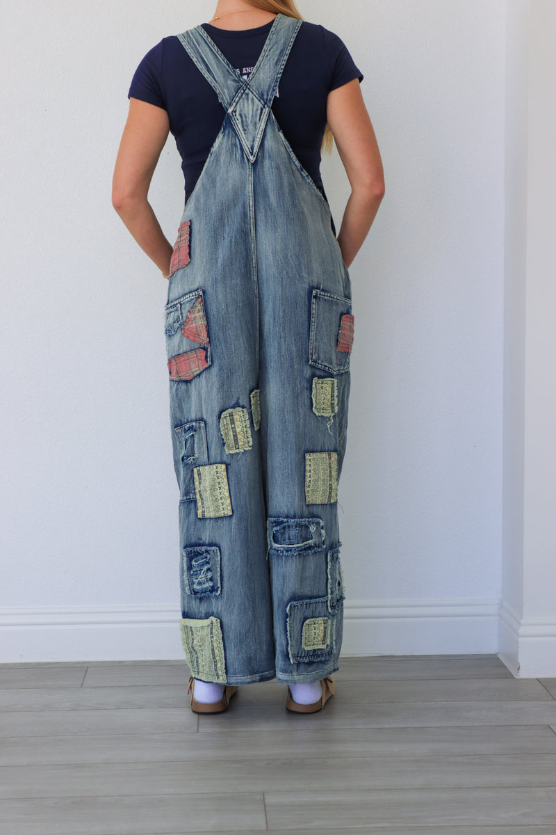 woman wearing patchwork blue overalls
