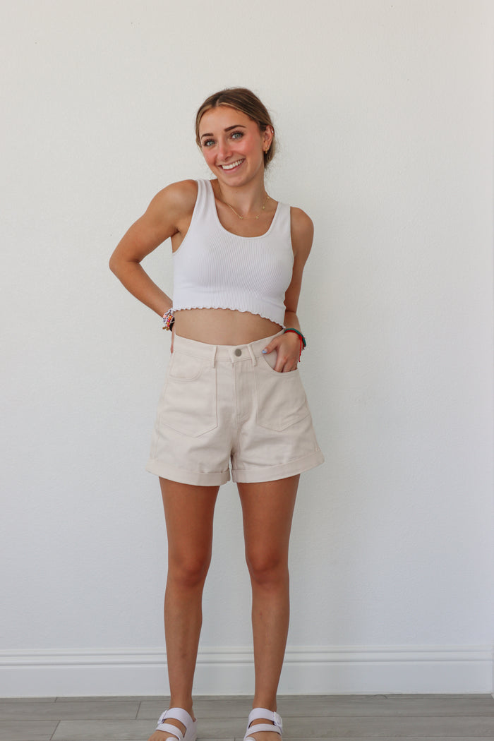 girl wearing cream shorts