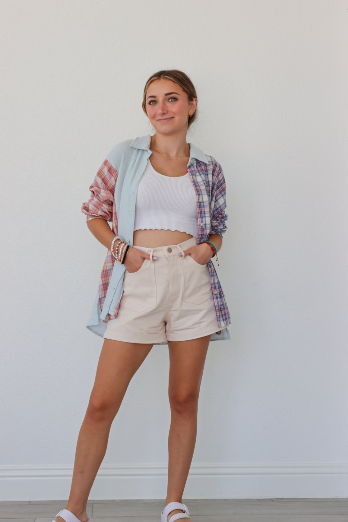 girl wearing multicolored pastel plaid button up top