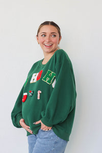 girl wearing dark green "ho ho ho" crewneck