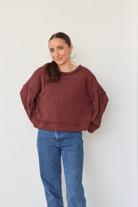 girl wearing dark red ribbed long sleeve top