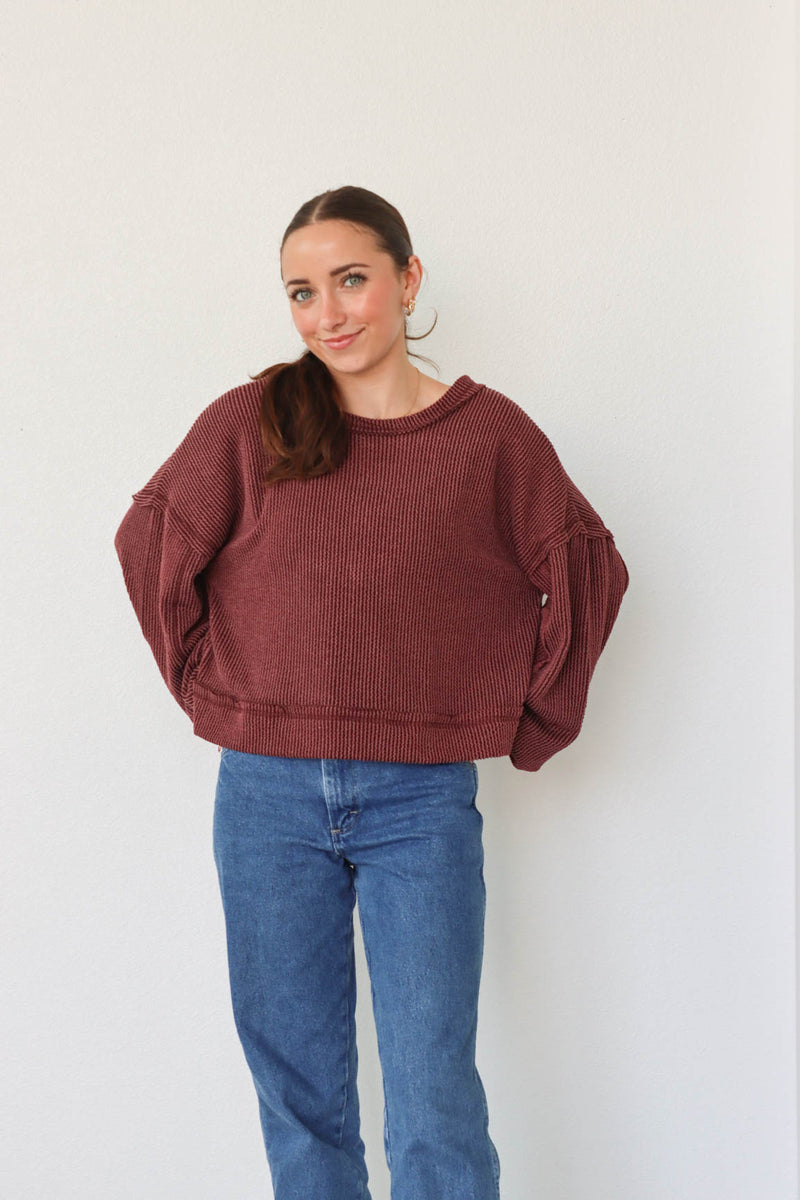 girl wearing dark red ribbed long sleeve top