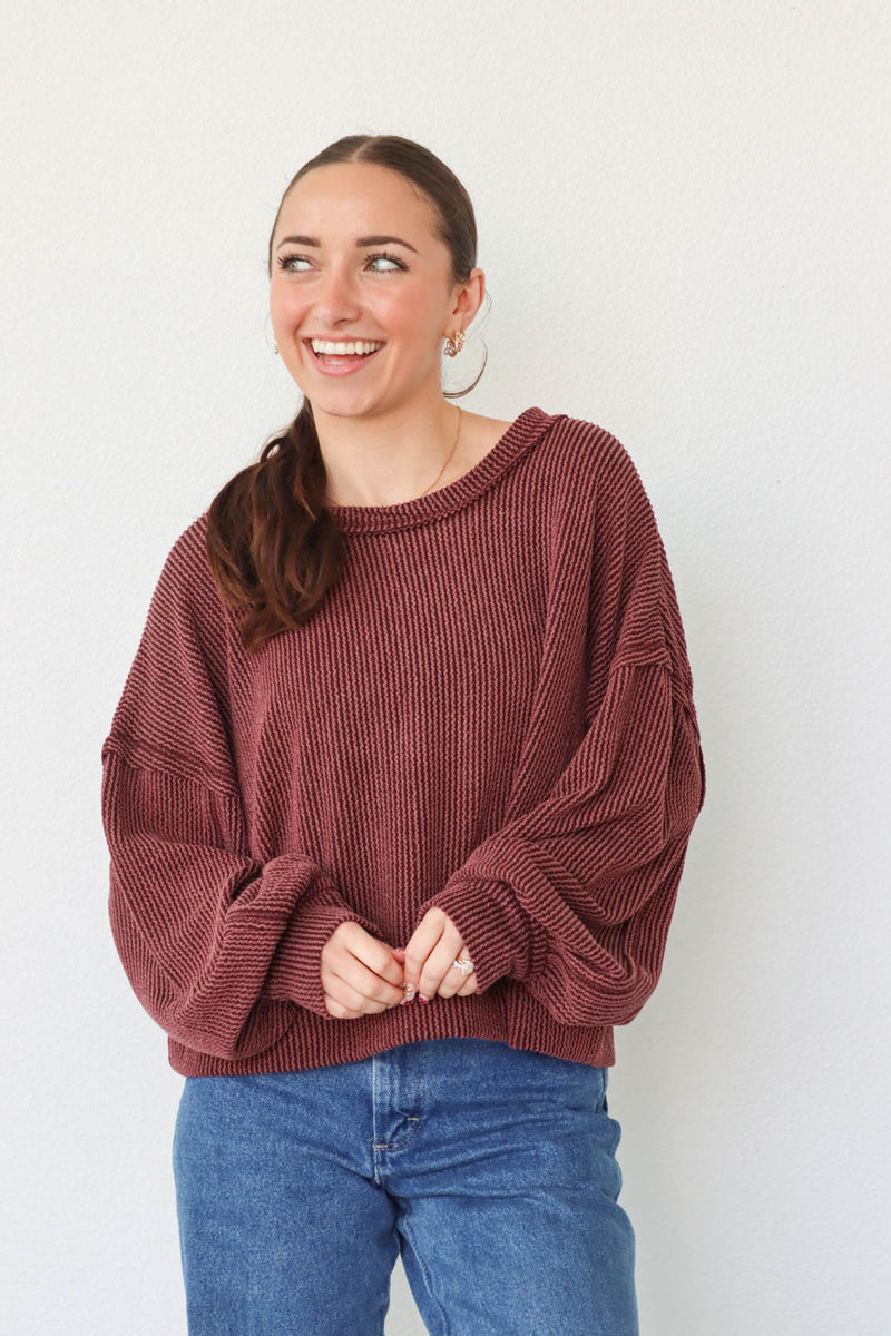 girl wearing dark red ribbed long sleeve top