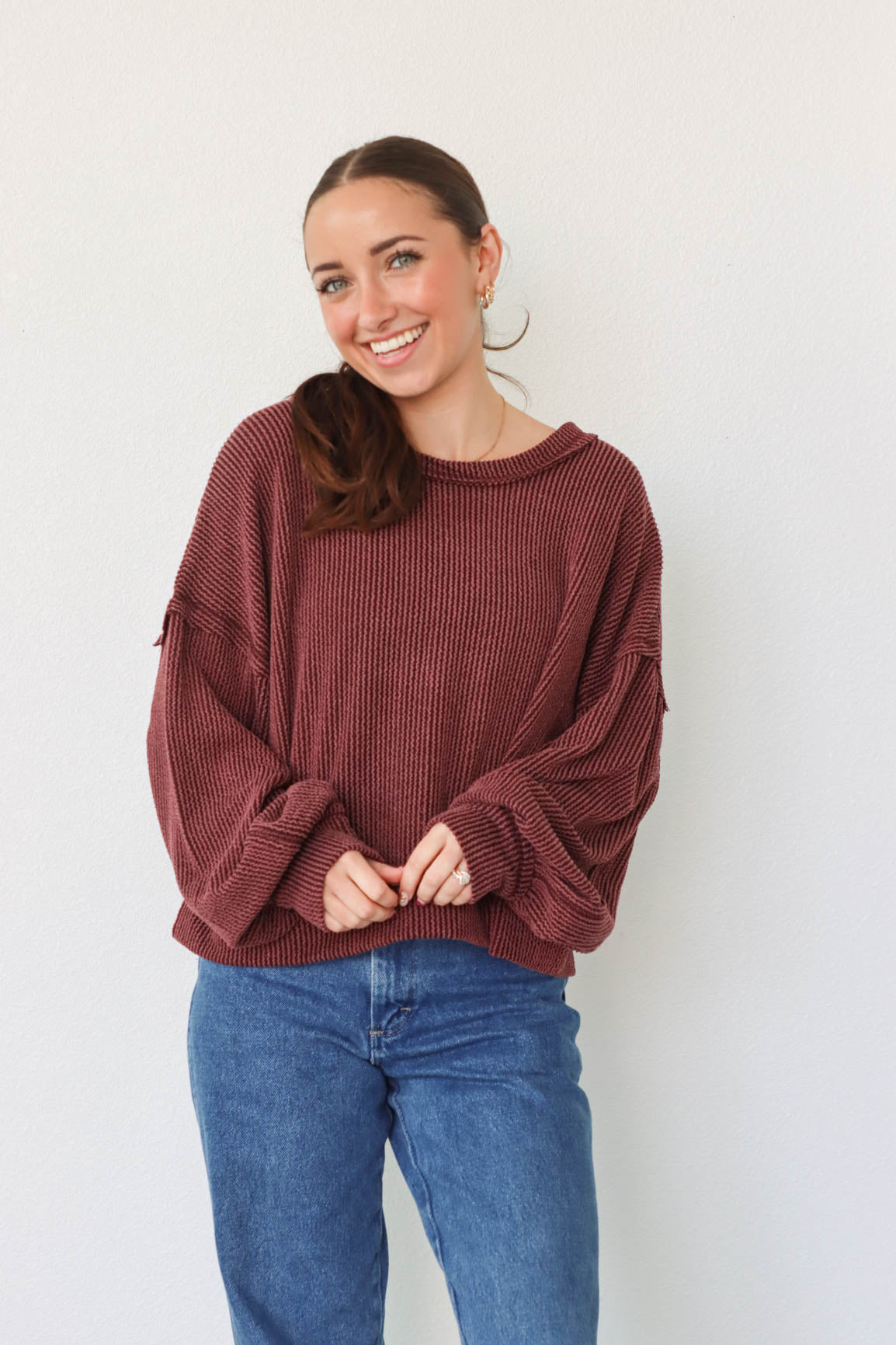 girl wearing dark red ribbed long sleeve top