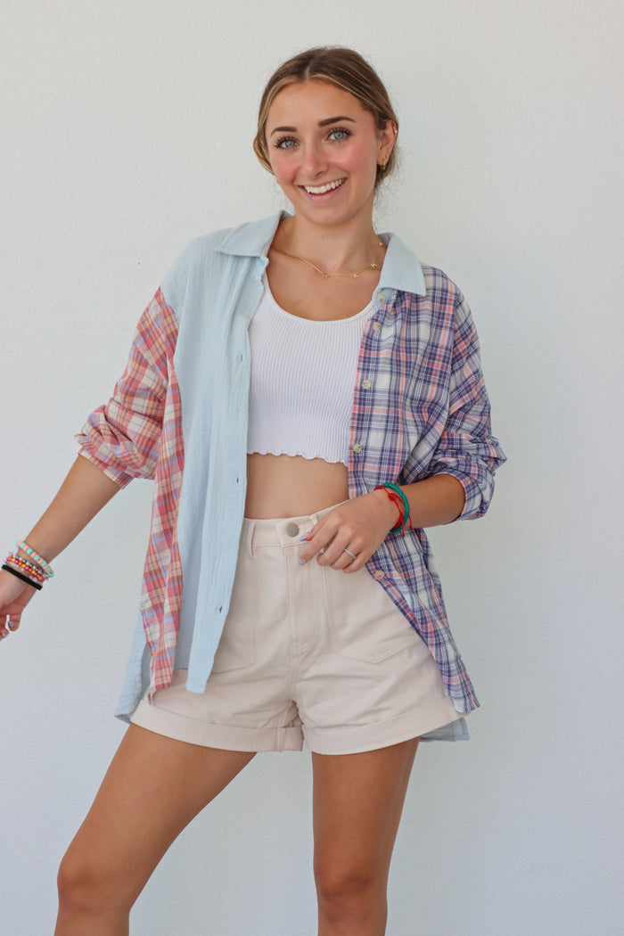 girl wearing multicolored pastel plaid button up top