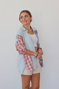 girl wearing multicolored pastel plaid button up top