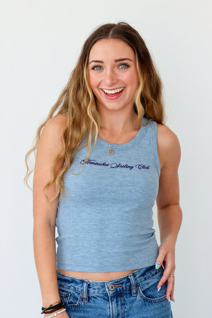 Woman wearing a blue tank top with text on a white background