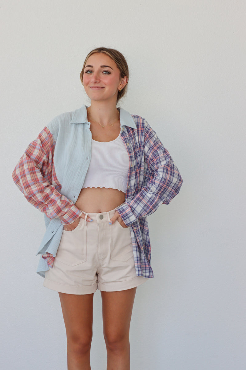 girl wearing multicolored pastel plaid button up top