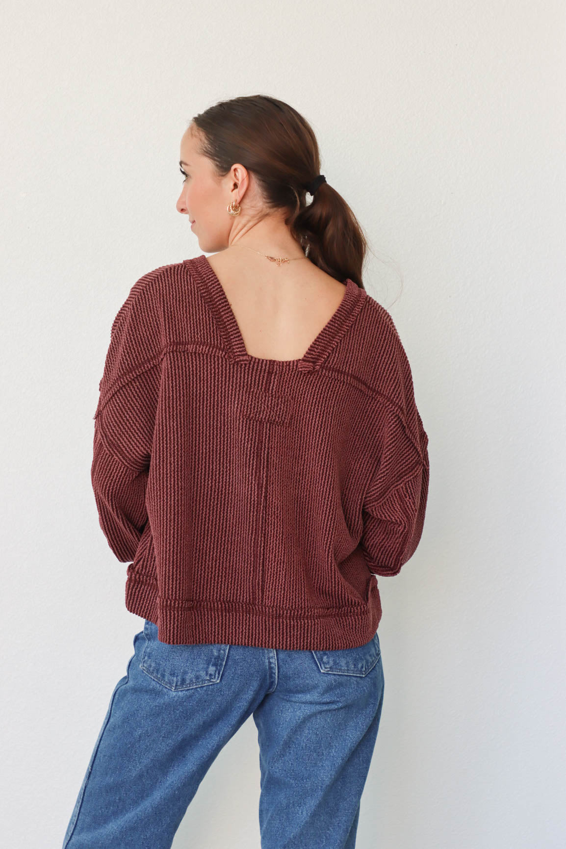 girl wearing dark red ribbed long sleeve top