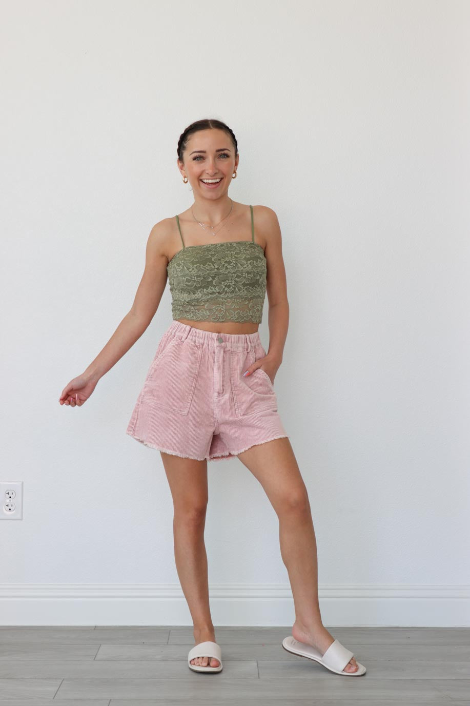 girl wearing light pink corduroy shorts