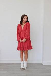 girl wearing red long sleeved flowy short dress